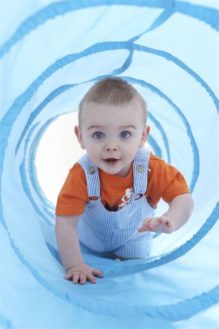 Toddler crawling inside tunnel